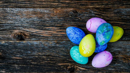 Painted and colored Easter eggs on rustic wooden table