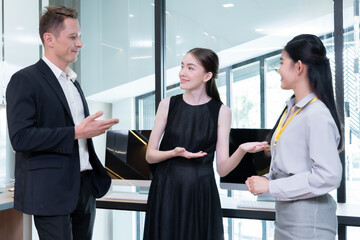 A female company employee is introducing the company's new female job offer to the team manager. where he came to work as a marketer in the office of a company.