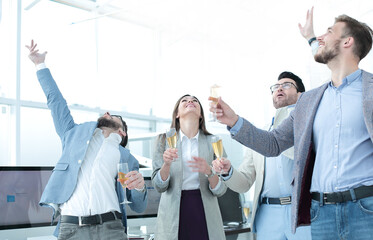 group of happy employees celebrate their success in the workplace