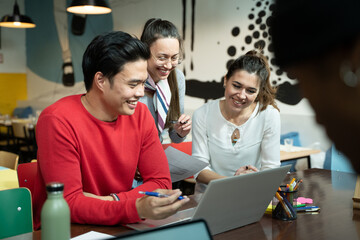 People work on a project in a co-working space laptop and stationary on the desk