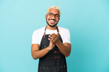 Restaurant Colombian waiter man isolated on blue background applauding after presentation in a conference