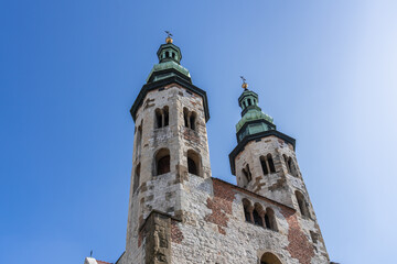 Two gothic towers in Old Krakow on a sunny day against a blue sky