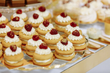 Wedding candy bar table. Cakes with cream and berries and other sweets. High quality photo