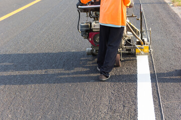 Machine eject and worker on road and traffic sign painting