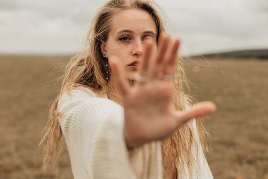 Woman showing stop gesture in field