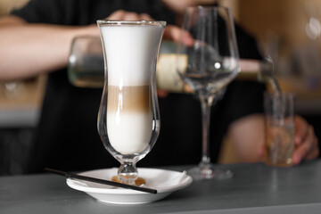 girl serving latte and cappuccino in a beautiful transparent glass, coffee shop concept