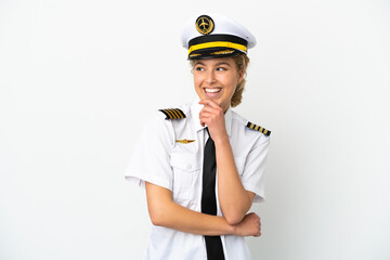 Airplane blonde woman pilot isolated on white background looking to the side and smiling