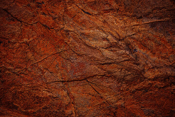 Red brown rock texture. Cracked mountain surface. Close-up. Stone background with space for design....