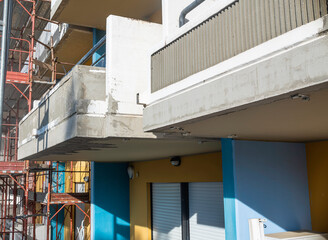 Balconies of condominium facade repaired after degradation and cracks in the reinforced concrete...