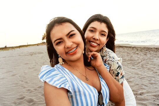 happy friends women taking a selfie on the beach.
