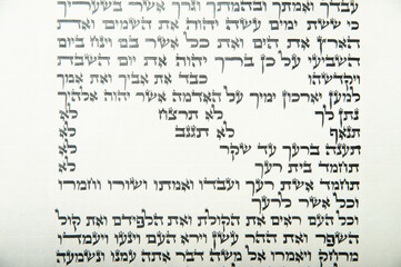 Closeup of a section of the Torah listing the 10 commandments.