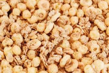 Dry muesli with cornflakes, nuts and raisins as texture background
