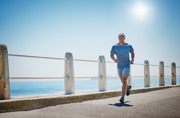 Fit and in form. Shot of a young sporty man running outside.