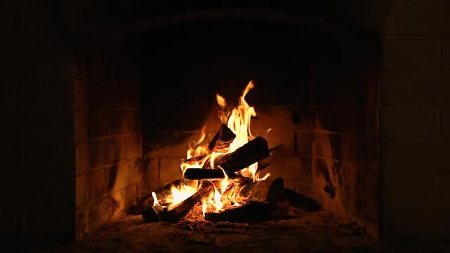 Warm Cozy Fireplace with Real Wood Burning in it. Cozy Winter Concept. Slow Motion. A Looping Clip of a Fireplace with Medium Size Flames