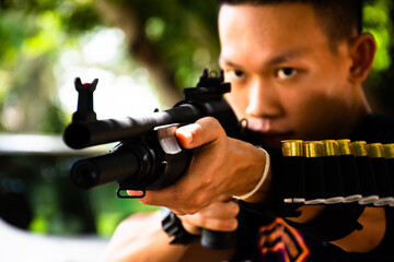 Shotgun shooter looking ahead to the shooting target while practising shotgun shooting.