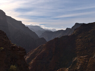 Beautiful view of the rugged mountains of western Gran Canaria, Spain near road GC-210 on cloudy day with rocks and steep canyon in winter season.