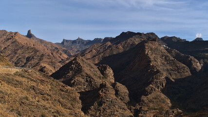 Barren landscape with the western mountains of Gran Canaria island, Spain on cloudy day in winter with rocks Roque Bentayga and Roque Nublo.