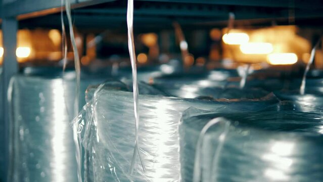 Rolls of fiberglass with the strings unwinding from them