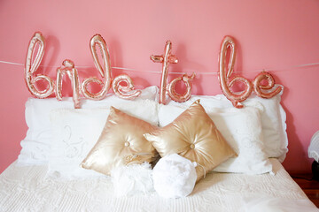Allestimento  in casa per una sposa con dei palloncini colorati posti sul letto della camera con la scritta "bride to be"