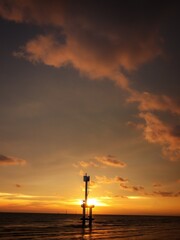 Fototapeta na wymiar silhouette of a small lighthouse on a sunset