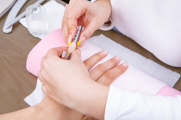 Obraz na płótnie Canvas step of manicure process: nail gel polish removal using foil pieces. High quality photo