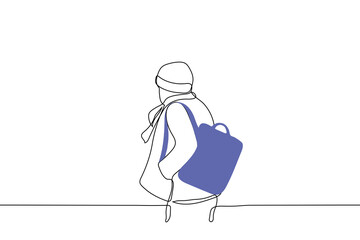 man in winter clothes walks with backpack on one shoulder - one line drawing vector. walking concept with blue backpack on the back