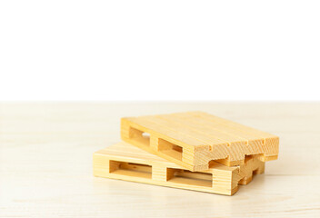 two pallets on a wooden floor on a white background