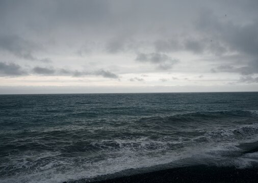 Dark natural background of inclement weather on the sea. Black sea and gray sky. Rain and waves. © Татьяна Пинкасевич