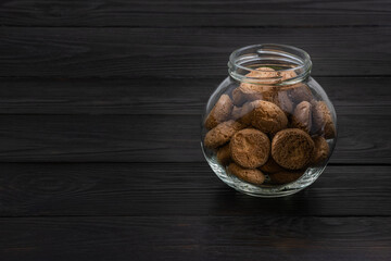 Jar of coffee cookies on dark table