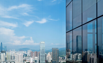 Fototapeta na wymiar Skyscrapers reflection in the office building window