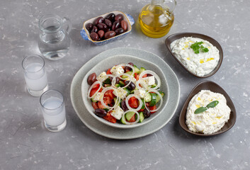 Greek salad with tzatziki, olives and feta cream. Traditional salad, meze,  with olive oil. Ouzo or Raki and traditional greek salad, tzatziki and olives