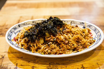 Fried rice with rice, vegetables, seaweed, gochujang, sesame oil, etc. in an iron plate, Korean traditional food,