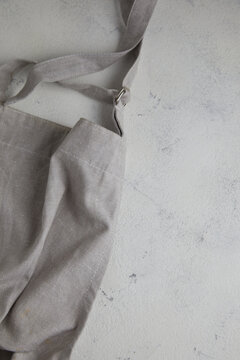 Apron on light rust textured background. Copy space.