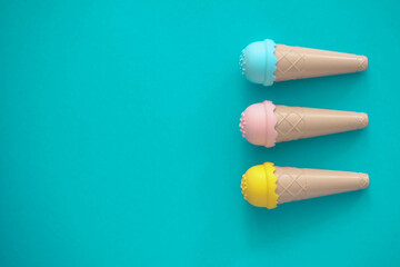 toy ice cream of different colors on a colored background 