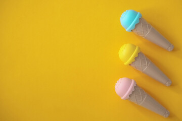 toy ice cream of different colors on a colored background 