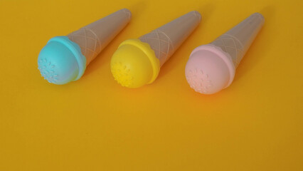 toy ice cream of different colors on a colored background 