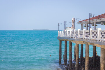 Stone Town landmark, Zanzibar. Tropical seascape in Stone Town. Wooden pier at the beach. Dock in Indian Ocean. Tropical travel. Amazing seaside in Tanzania. Scenic seascape.