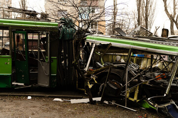 Fototapeta na wymiar The trolleybus was destroyed on the street after Russian shelling. consequences of the war in Ukraine. broken transport.