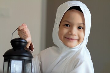Muslim kid preparing lantern for ramadan holy month.Asian Muslim kid in traditional suit happy in...