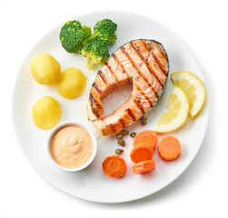 plate of grilled salmon steak and vegetables