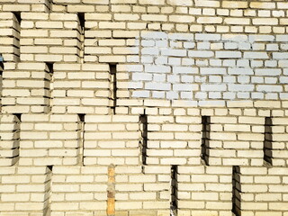 Textured yellow brick wall. Space for text. Horizontal format.