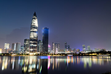 Fototapeta premium Office building reflected in the water at night