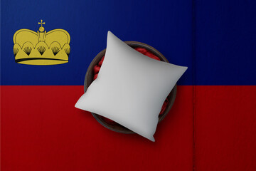 Patriotic pillow mock up on background in colors of national flag. Liechtenstein