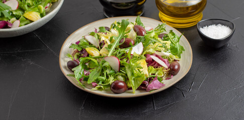Fresh green vegan salad from green leaves mix vegetables and olives. 