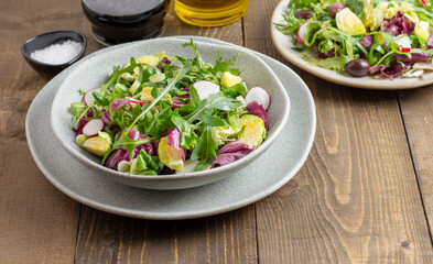 Vitamin salad with lettuce, spring onions, brussels sprout, cabbage, arugula and radish. Close up