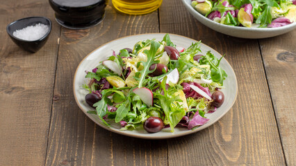 Vitamin salad with lettuce, spring onions, brussels sprout, cabbage, arugula and radish. Close up