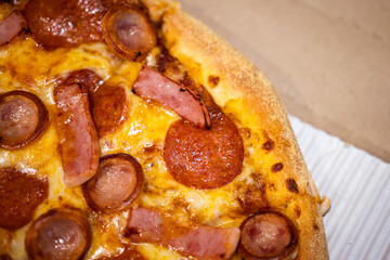 Italian food, baked pizza with pork meat and sausage topping. Food top view close-up photo.