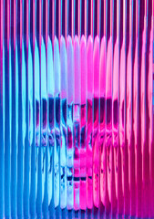 Neon illuminated human skull behind blurred glass with lines. Spooky, cyber Halloween background.