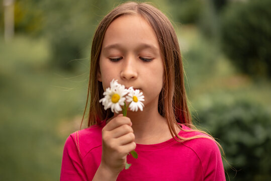 Portrait of a girl in nature and in ruach flowers.