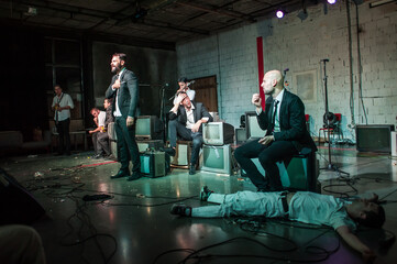Large group of theater actor artists on stage perform play